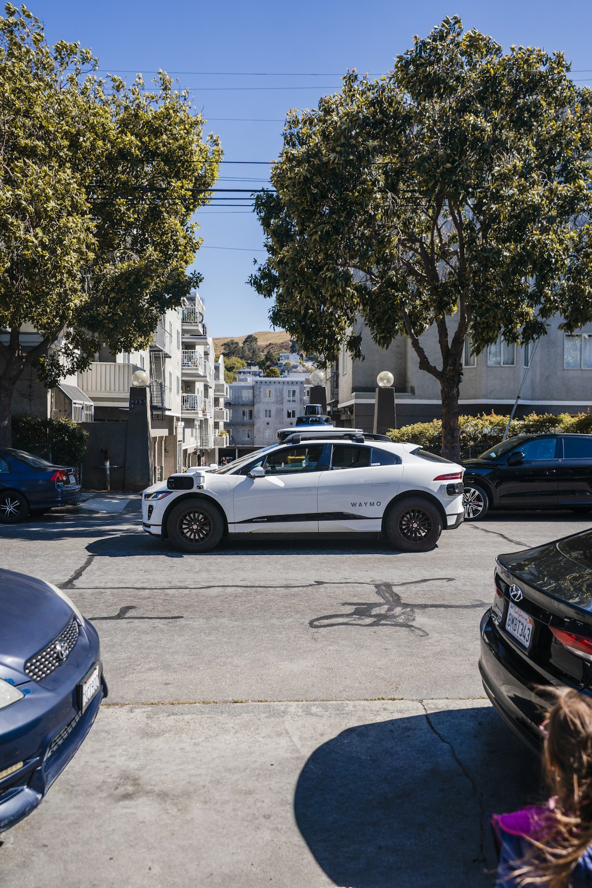 Autonomous vehicle on city street representing technological displacement