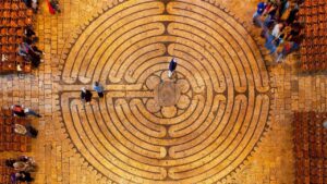 Aerial view of people walking a stone labyrinth - finding your true value hierarchy